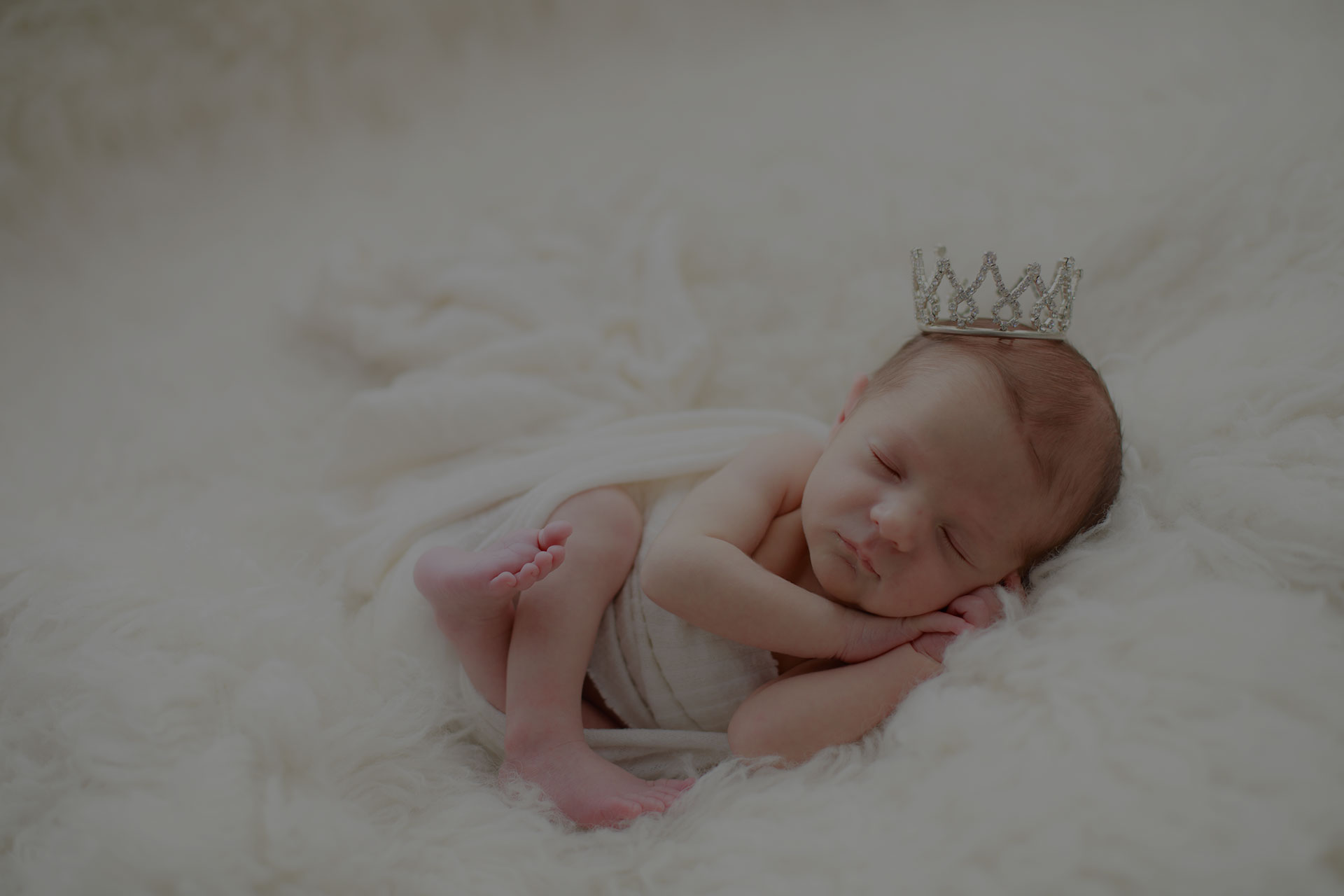 Sleeping newborn wearing a delicate crown during a Brisbane studio portrait session