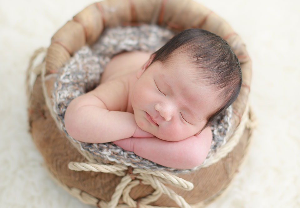 sleeping baby on a basket